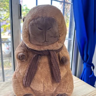 Peluche capibara con mantas